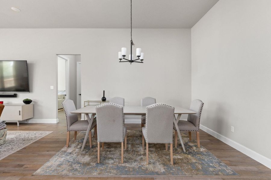 Dining room featuring wood finished floors and a chandelier