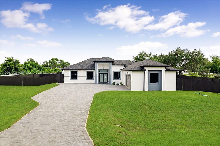 Front exterior of a new home in , Lehigh Acres, FL, highlighting curb appeal (Image 2). Front exterior of a new home in , Lehigh Acres, FL, highlighting curb appeal (Image 2).