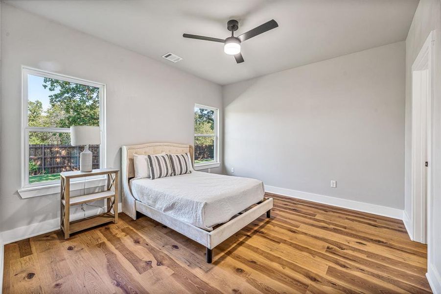 Bedroom featuring wood finished floors and a ceiling fan Bedroom featuring wood finished floors and a ceiling fan