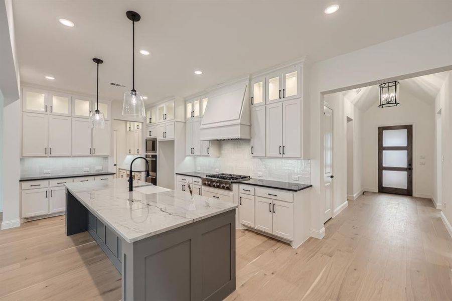 Kitchen with premium range hood and white cabinets