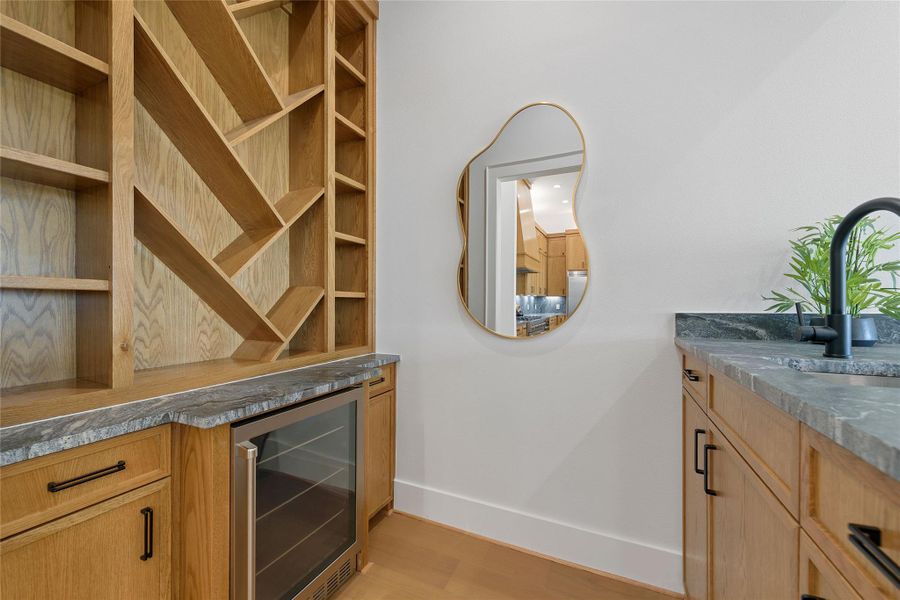 Chic and functional, this built-in bar area is perfect for mixing cocktails or morning coffee. Featuring modern finishes and a wood-accented backsplash, it’s a standout space for entertaining in your Canyon Lake home.