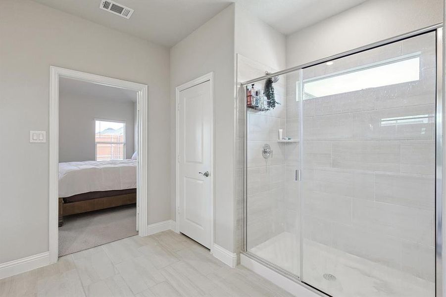 Bathroom with walk in shower and tile floors