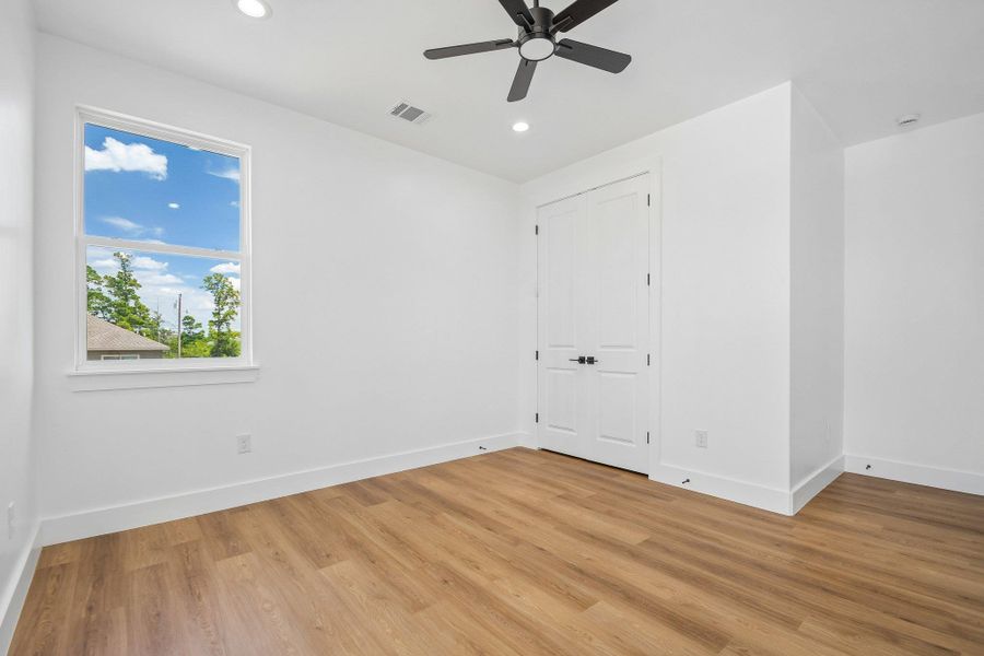 Warm wood flooring and clean white walls create a serene, minimalist atmosphere. Warm wood flooring and clean white walls create a serene, minimalist atmosphere.