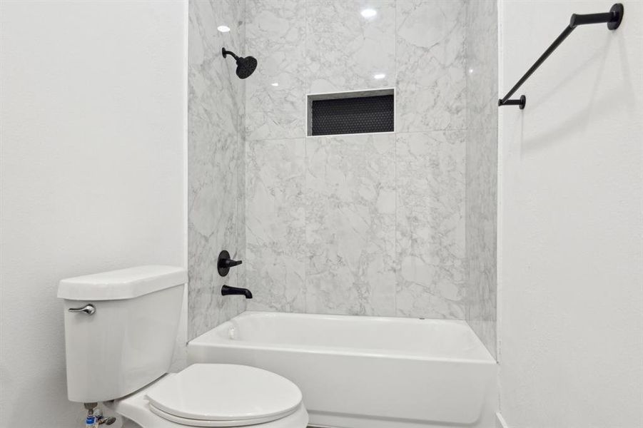 Bathroom featuring toilet and shower / tub combination