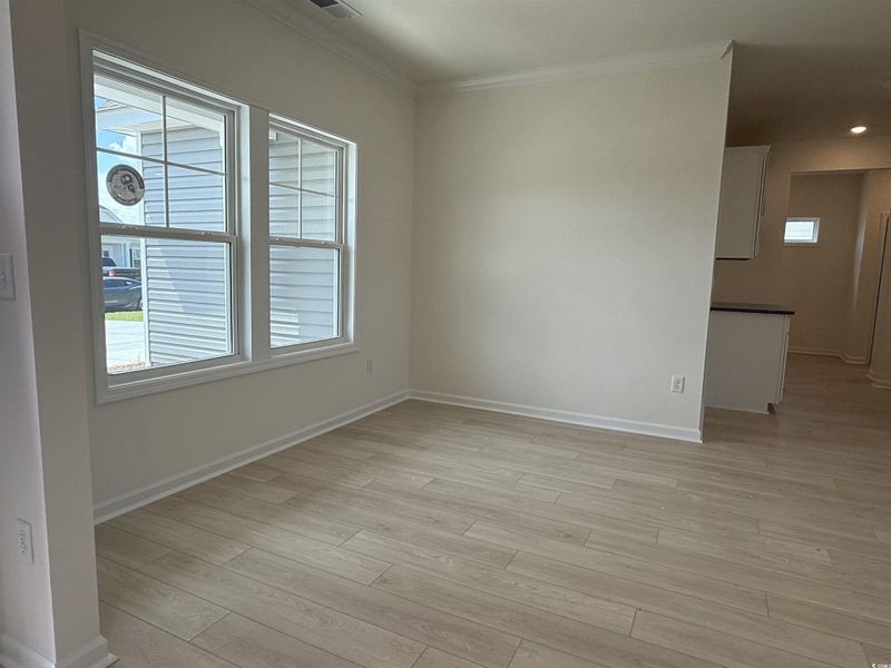Kitchen with open floor plan, dark countertops, stainless steel range with electric stovetop, white cabinets, and recessed lighting Kitchen with open floor plan, dark countertops, stainless steel range with electric stovetop, white cabinets, and recessed lighting