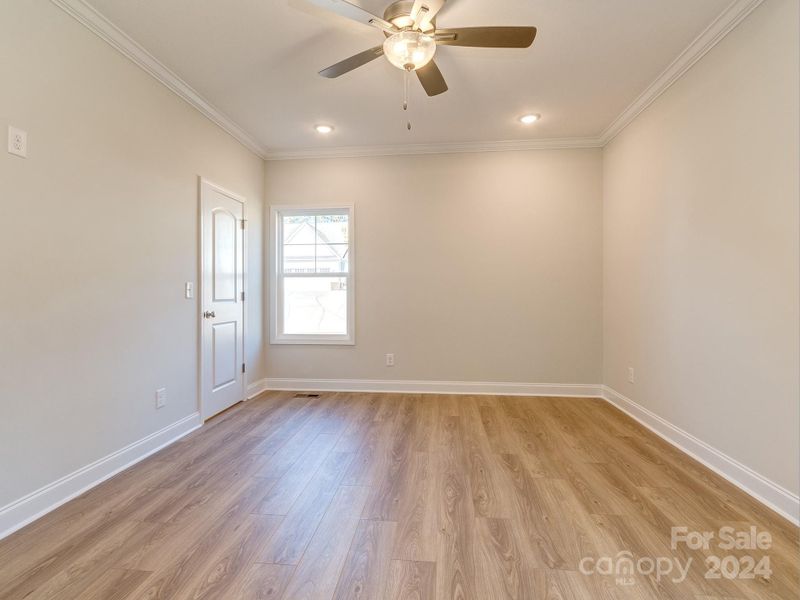 Main floor primary suite with wood floors