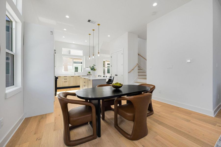 Elegant dining area seamlessly connected to a modern kitchen, perfect for entertaining and family gatherings.