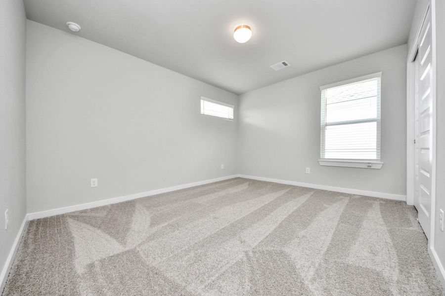 Generously sized secondary bedrooms featuring spacious closets, soft and inviting carpeting underfoot, large windows allowing plenty of natural light, and the added touch of privacy blinds for your personal retreat.