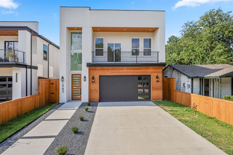 Contemporary house featuring a balcony and a garage