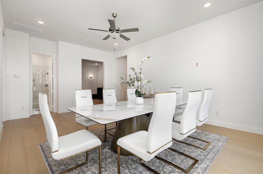 Dining space featuring light wood-style floors, ceiling fan, and recessed lighting