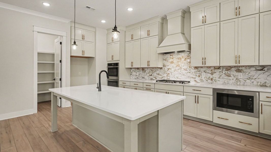 Elevated kitchen features in the Solace II home plan such as a gourmet kitchen with various cabinets and island Elevated kitchen features in the Solace II home plan such as a gourmet kitchen with various cabinets and island