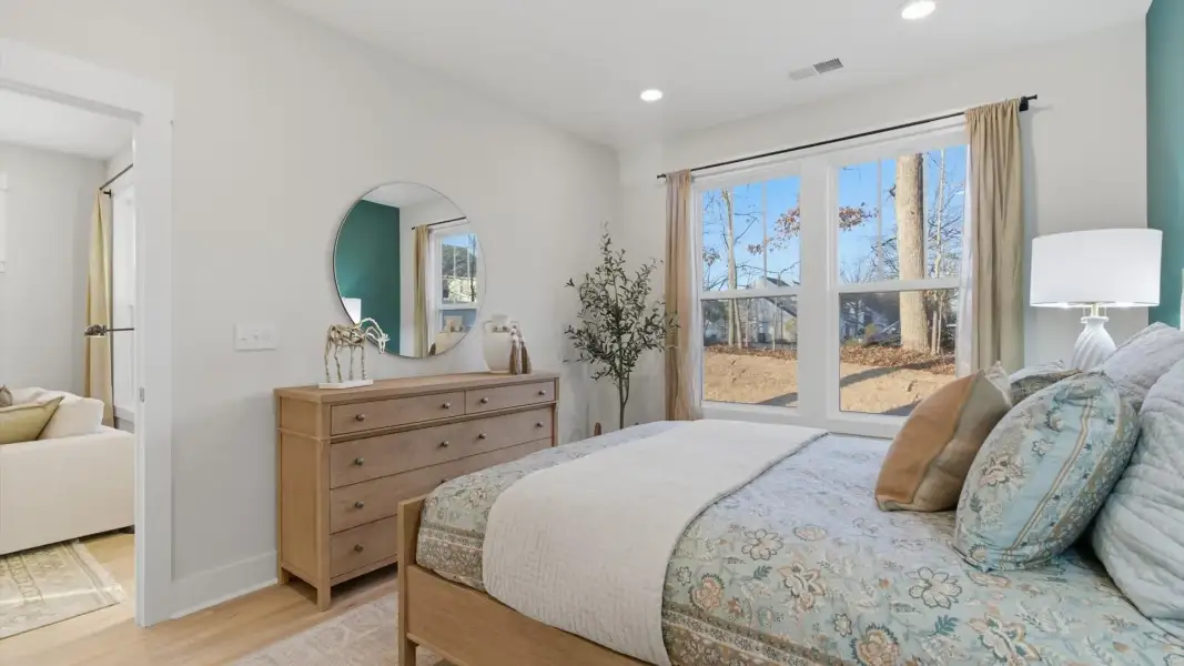 Eye-catching details and elegant finishes in the vibrant primary suite of this select villa in Greenville, SC