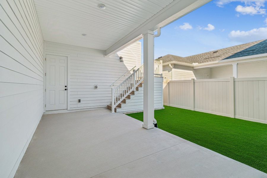 Exterior details and patio area of a home in Seven Pines 24' Rear Entry Townhomes, Jacksonville (Image 3).