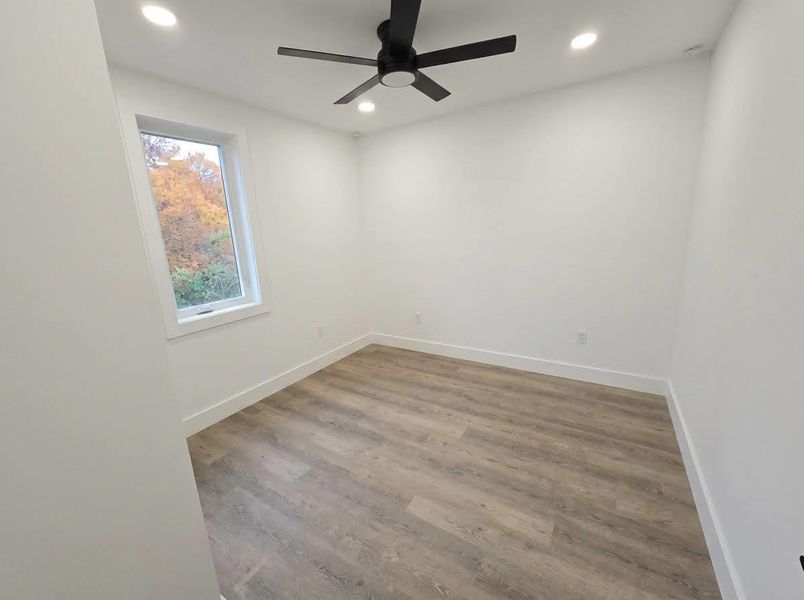 Empty room with light wood-type flooring, recessed lighting, and a ceiling fan