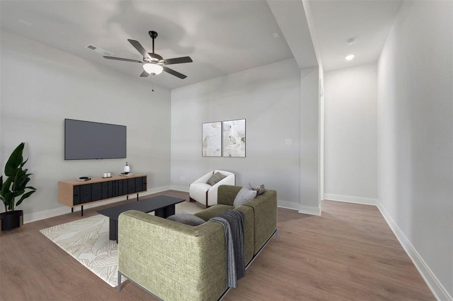Living area with light wood finished floors and ceiling fan