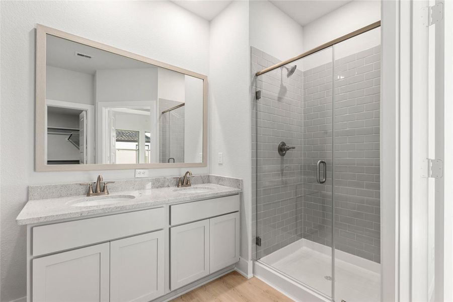 This beautifully finished bathroom features a double-sink vanity, walk-in glass shower, and sleek neutral tones throughout. Its clean lines and bright design create a calming, spa-inspired retreat. This beautifully finished bathroom features a double-sink vanity, walk-in glass shower, and sleek neutral tones throughout. Its clean lines and bright design create a calming, spa-inspired retreat.