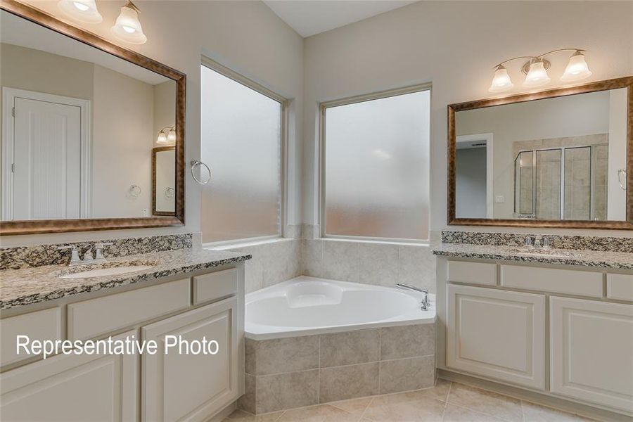 Bathroom featuring vanity, tile patterned floors, and separate shower and tub