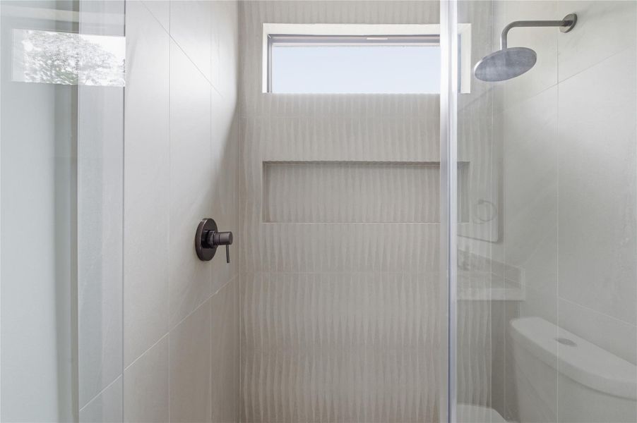 Conveniently located off the main living area, this stylish full guest bath offers both comfort and privacy for visitors.