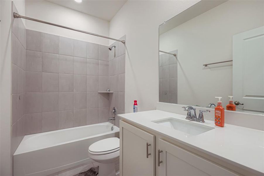 Full bath featuring  shower combination and vanity