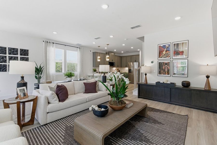 A living room with a large rug.
