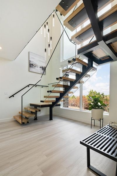 Stairway featuring wood finished floors and baseboards