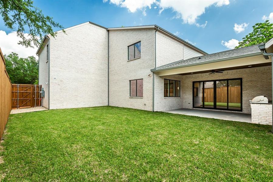 Grassed yard with privacy fence