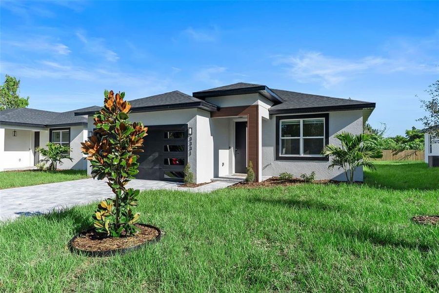 Front exterior of a new home in , Orlando, FL, highlighting curb appeal (Image 2).