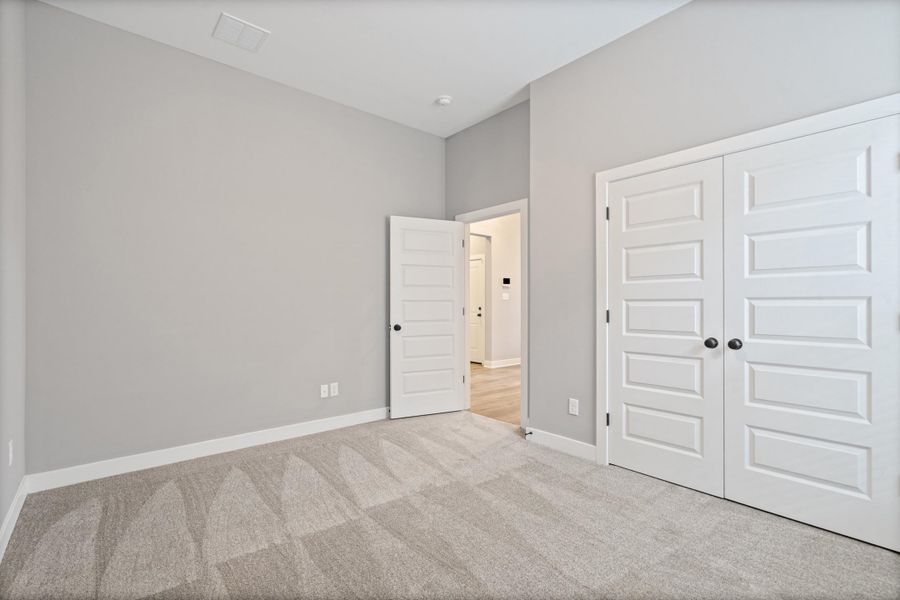Neutral-toned wall paint and light-colored carpet flooring Neutral-toned wall paint and light-colored carpet flooring