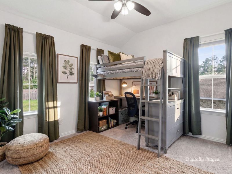 Bedroom filled with natural light from multiple windows, finished with a vaulted ceiling and a ceiling fan. The carpeted, flexible layout suits a variety of furniture arrangements. This photo has been digitally staged to illustrate the possibilities of the home's aesthetic and potential design. Some furnishings and décor shown are for visual inspiration.