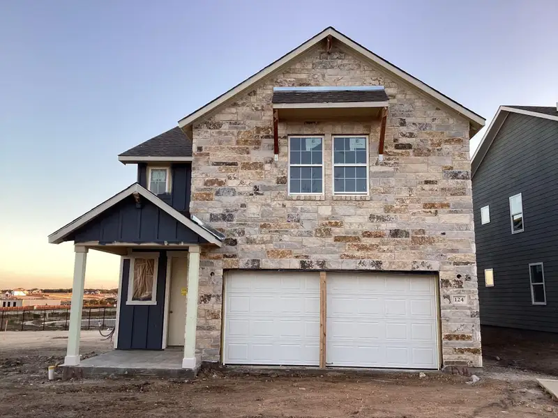 Front exterior of a new home in The Homestead at Lariat, Liberty Hill, TX, highlighting curb appeal (Image 1).