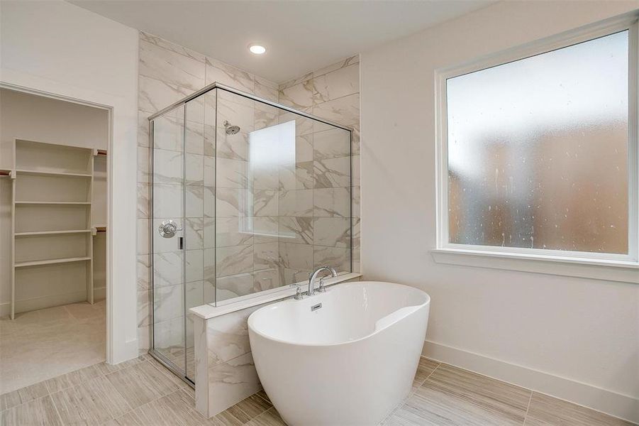 Bathroom with tile floors and shower with separate bathtub