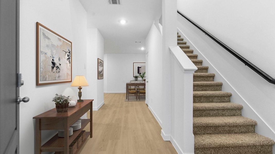 Entry hallway leading to living room and kitchen in the background. Entry hallway leading to living room and kitchen in the background.