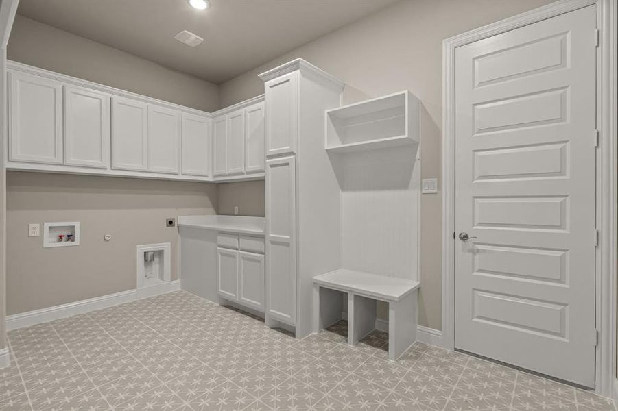 Laundry room with hookup for a gas dryer, electric dryer hookup, hookup for a washing machine, and cabinets