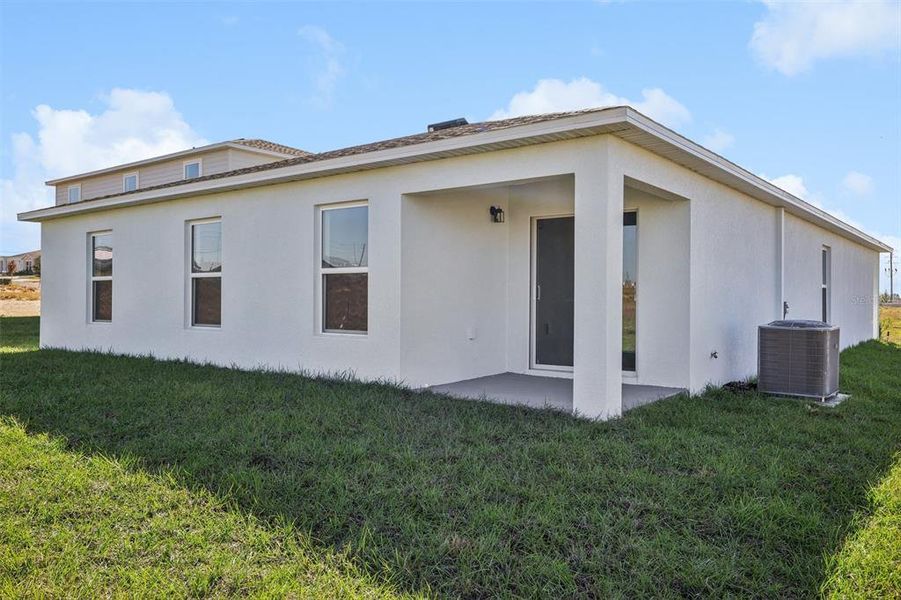 Exterior details and patio area of a home in The Enclave at Scenic Terrace, Haines City (Image 10).