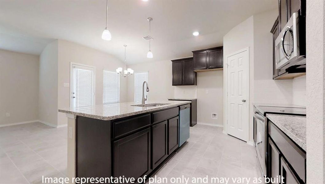 Kitchen featuring light stone countertops, hanging light fixtures, stainless steel appliances, a center island with sink, and a chandelier Kitchen featuring light stone countertops, hanging light fixtures, stainless steel appliances, a center island with sink, and a chandelier