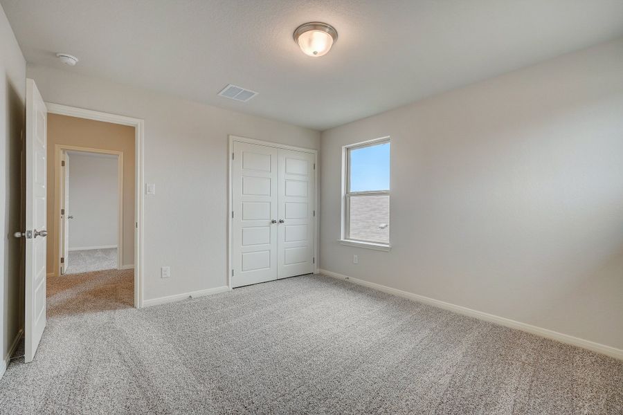 Guest bedroom in the Pearl floorplan at a Meritage Homes community.