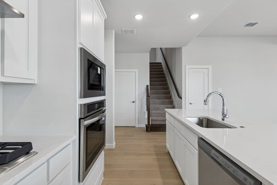 Kitchen in the Stanley II home plan by Trophy Signature Homes – REPRESENTATIVE PHOTO