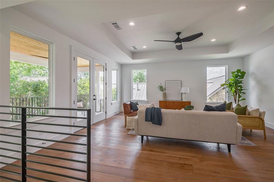 Living room 2 featuring ceiling fan, a raised ceiling, and dark hardwood / wood-style flooring