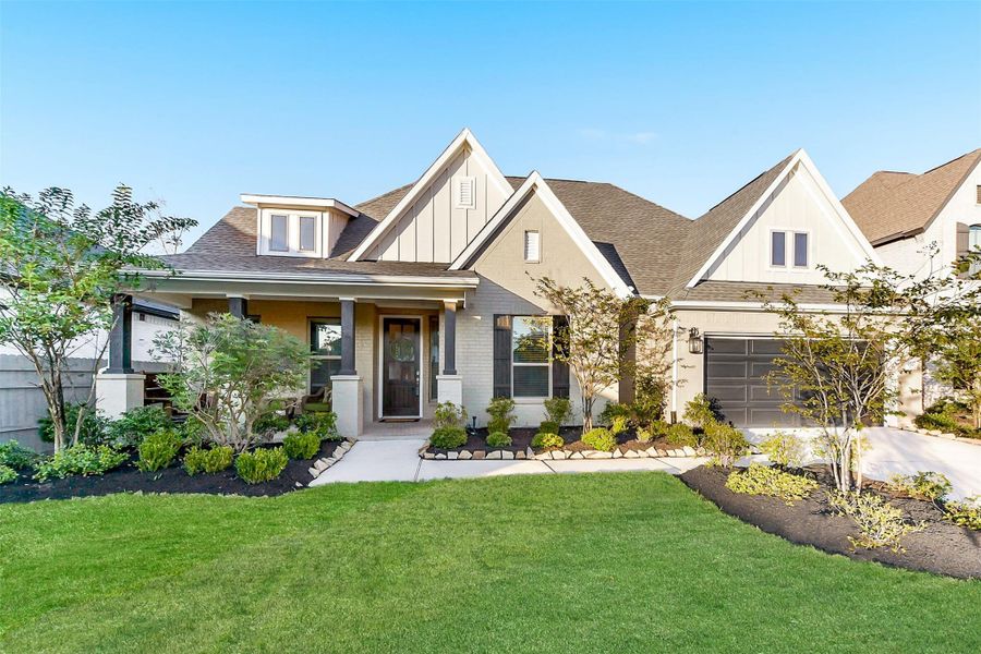 Front exterior of a new home in ARTAVIA 65', Conroe, TX, highlighting curb appeal (Image 1).