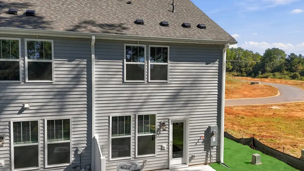 Refined rear exterior design with balanced architectural detail in this distinguished two-story townhome near Lake Hartwell