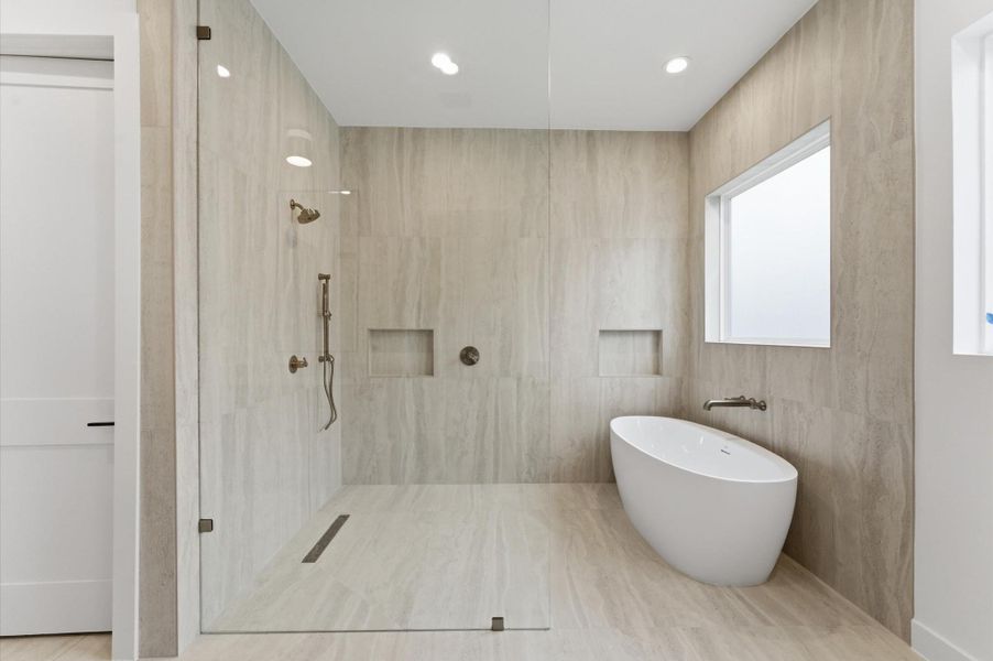 The primary bathroom features a large shower and stand alone soaking tub.