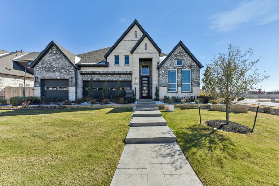 Front exterior of a new home in The Grove at Blackhawk, Pflugerville, TX, highlighting curb appeal (Image 30).