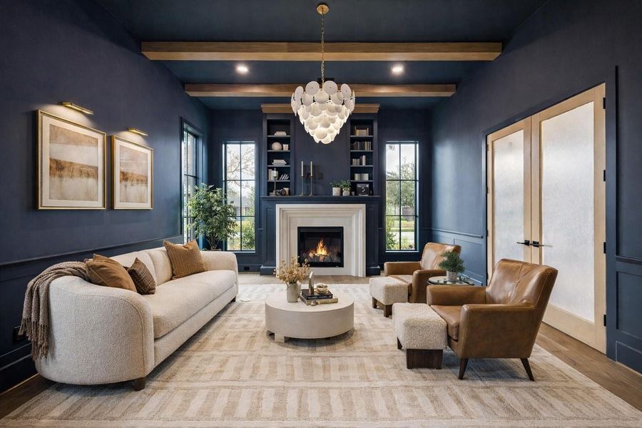 Moody designer office wrapped in rich paneled walls, custom built ins, and exposed wood ceiling beams. Fireplace, statement chandelier, and layered seating create a luxury work from home retreat with warmth, texture, and architectural depth. *Virtually Staged*