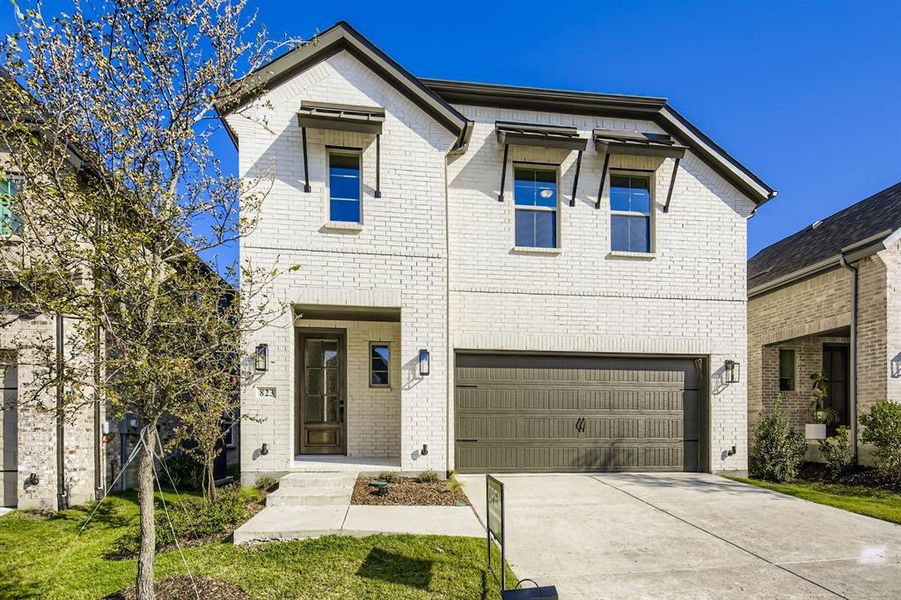 View of front of home with brick siding, driveway, and an attached garage View of front of home with brick siding, driveway, and an attached garage