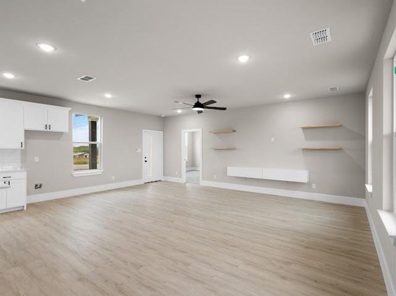 Unfurnished living room featuring light wood-style flooring, recessed lighting, and a ceiling fan
