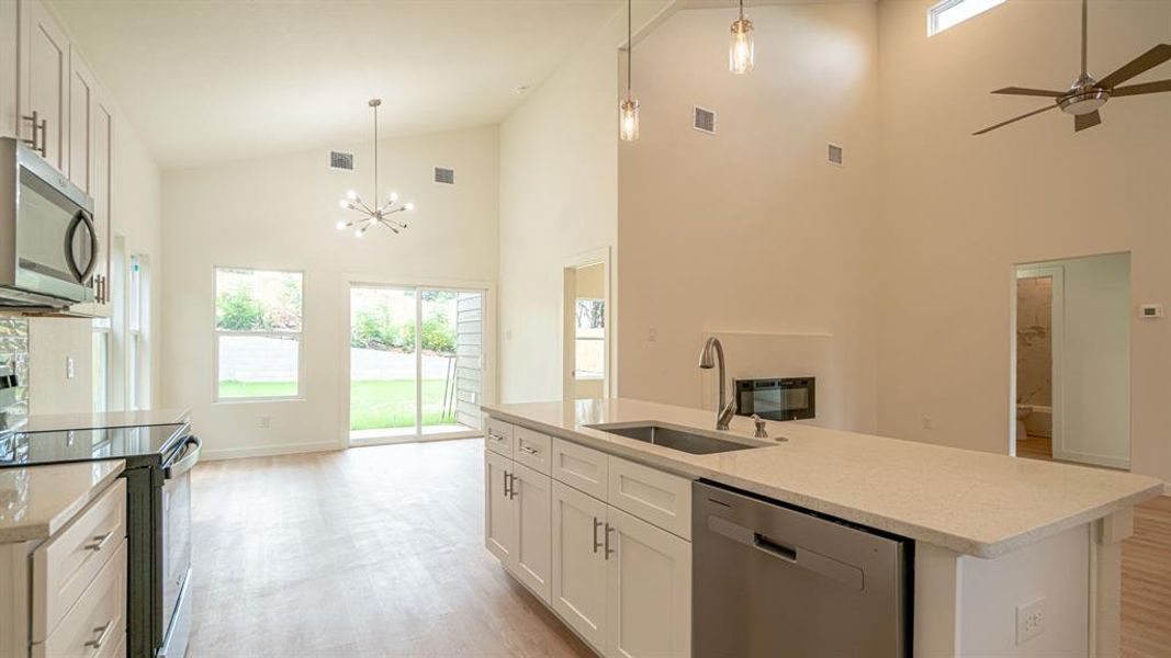 Open layout with kitchen, living and dining areas