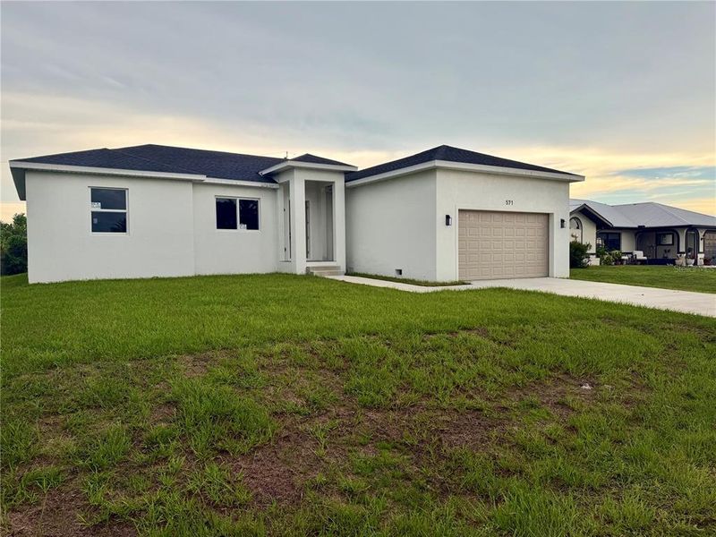 Front exterior of a new home in , Port Charlotte, FL, highlighting curb appeal (Image 13). Front exterior of a new home in , Port Charlotte, FL, highlighting curb appeal (Image 13).
