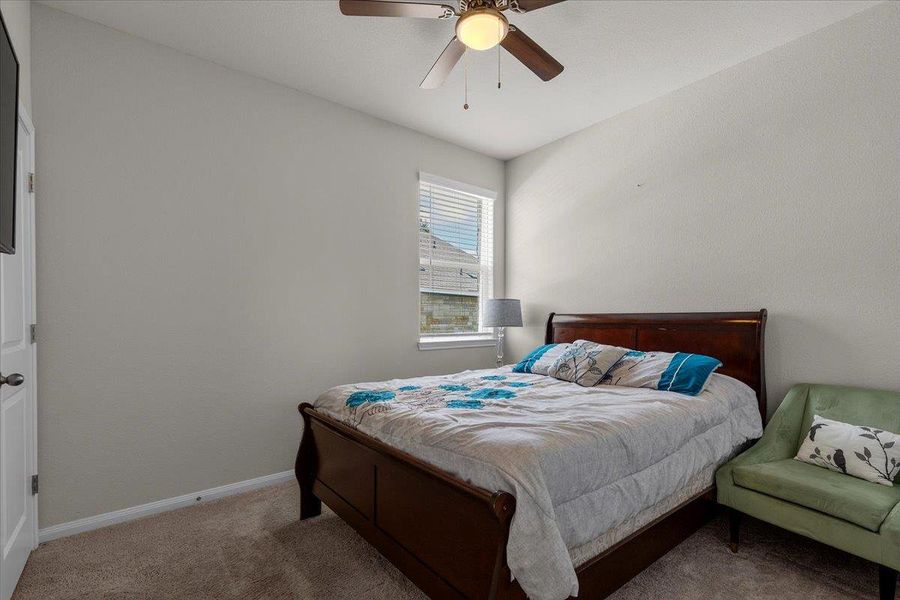 Soft carpet flooring and tall walls under a high ceiling define this cozy space.