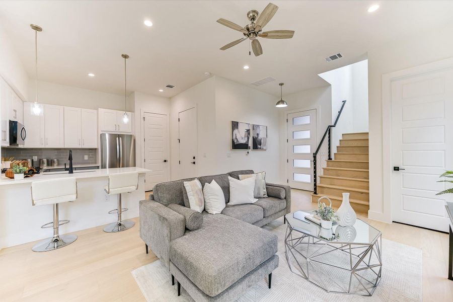 Designed for the entertainer, this perspective highlights the movement between the cozy lounge area and the chef’s kitchen. The neutral tones and recessed lighting provide a blank canvas for your personal style.