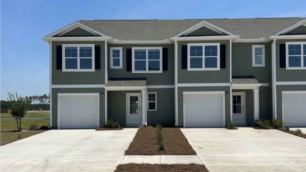 Front exterior of a new home in The Landing at Sidbury Station, Castle Hayne, NC, highlighting curb appeal (Image 1). Front exterior of a new home in The Landing at Sidbury Station, Castle Hayne, NC, highlighting curb appeal (Image 1).
